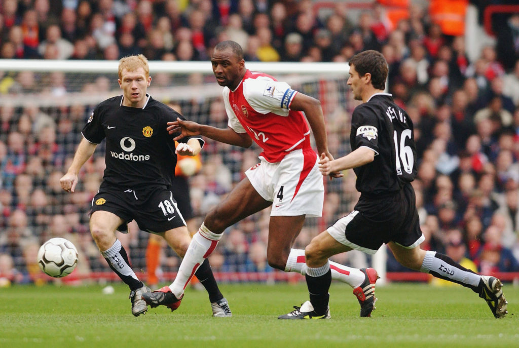 Patrick Vieira of Arsenal takes the ball between Paul Scholes and Roy Keane of Manchester United during the FA Barclaycard Premiership match betwee...