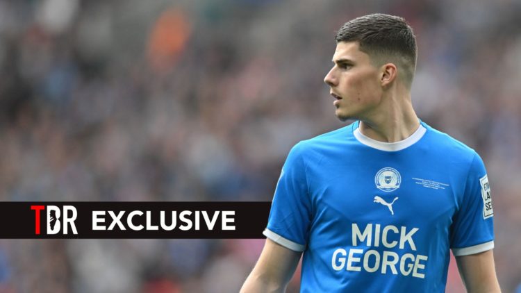 Ronnie Edwards of Peterborough United is looking on during the EFL Trophy match.