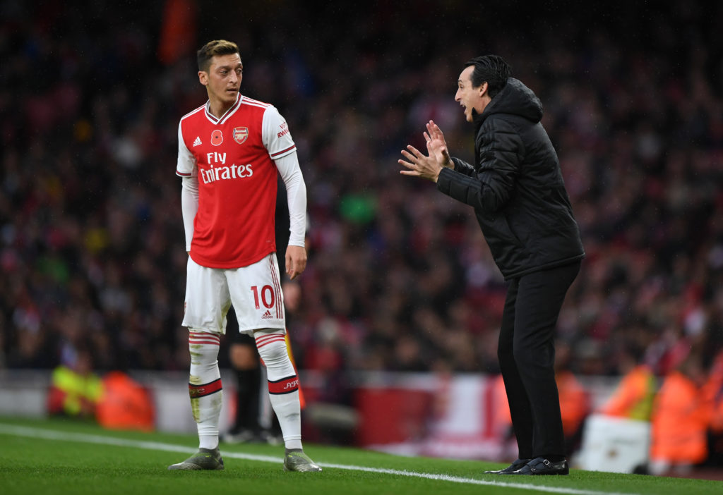 Mesut Ozil of Arsenal and Unai Emery the head coach / manager of Arsenal during the Premier League match between Arsenal FC and Wolverhampton Wande...