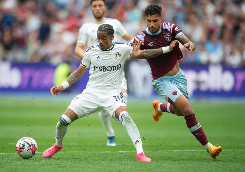 Crysencio Summerville of Leeds United (L) holds off Emerson Palmieri of West Ham United (R) during the Premier League match between West Ham United...