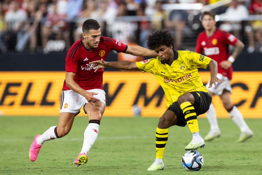 Diogo Dalot of Manchester United and Karim Adeyemi of Borussia Dortmund battle for the ball during the pre-season friendly match between Manchester...