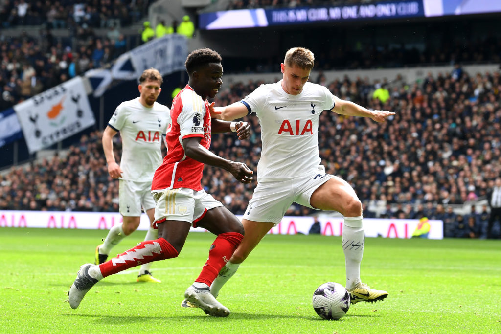 Bukayo Saka of Arsenal is challenged by Micky van de Ven of Tottenham Hotspur during the Premier League match between Tottenham Hotspur and Arsenal...