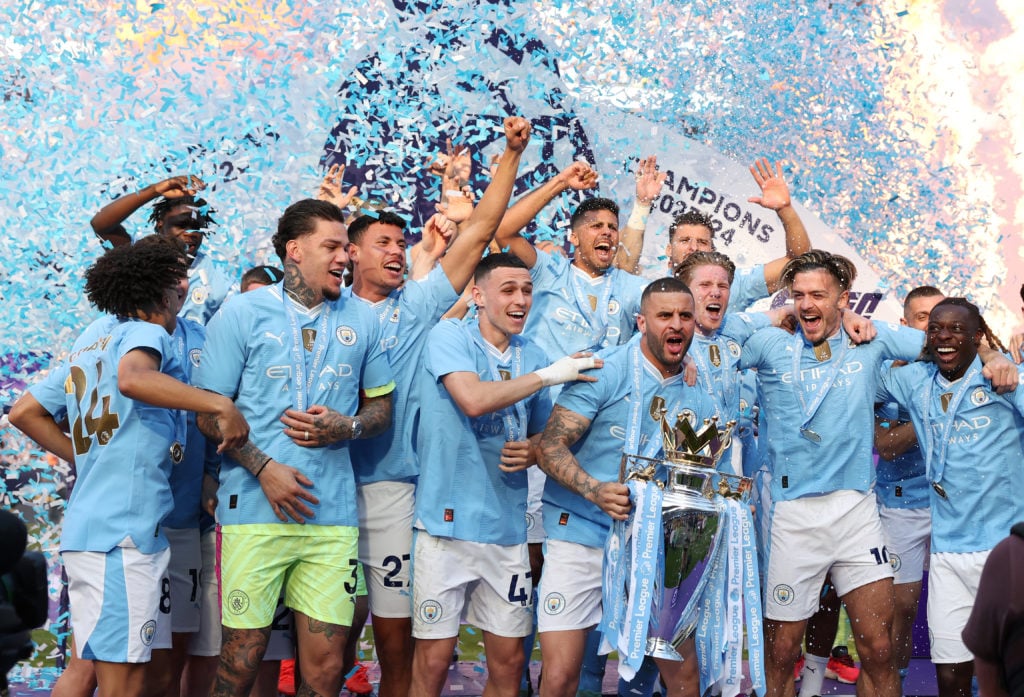 Kyle Walker of Manchester City lifts the Premier League trophy alongside team mates after the Premier League match between Manchester City and West...