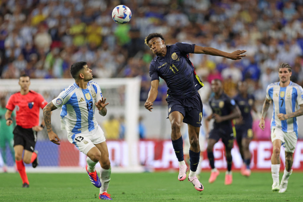 Argentina's defender #13 Cristian Romero fights for the ball with Ecuador's forward #11 Kevin Rodríguez during the Conmebol 2024 Copa America tourn...