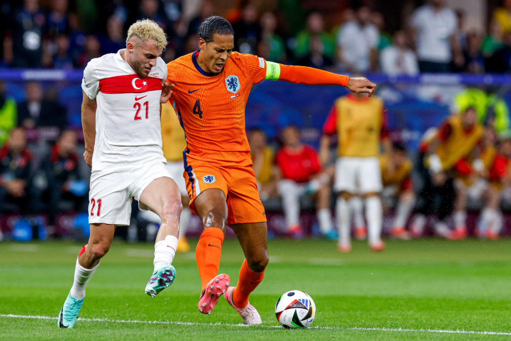 Baris Alper Yilmaz of Turkiye battles for possession with Virgil van Dijk of Netherlands during the UEFA EURO 2024 quarter-final match between Neth...