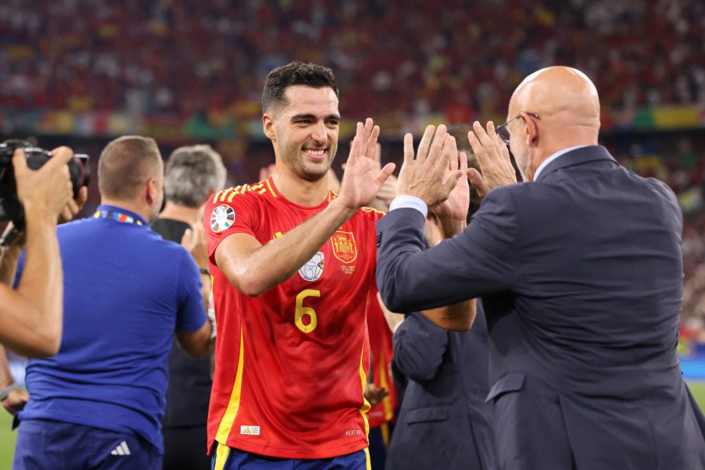 Mikel Merino of Spain celebrates victory with Luis de la Fuente, Head Coach of Spain, after the UEFA EURO 2024 Semi-Final match between Spain and F...