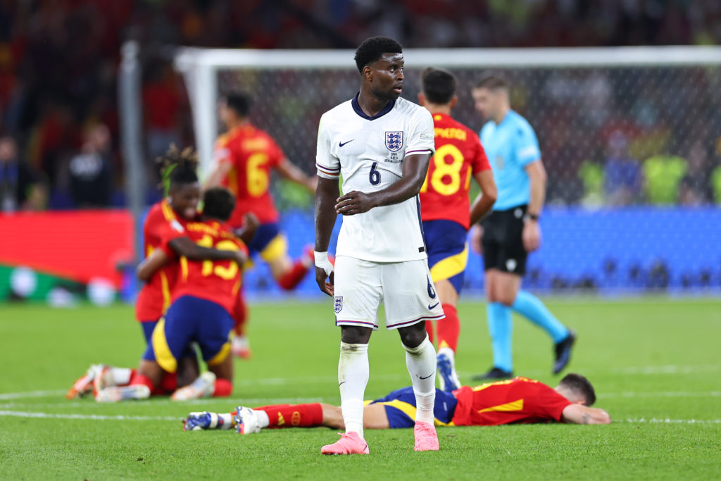 A dejected Marc Guehi of England as players of Spain celebrate  during the UEFA EURO 2024 final match between Spain and England at Olympiastadion o...