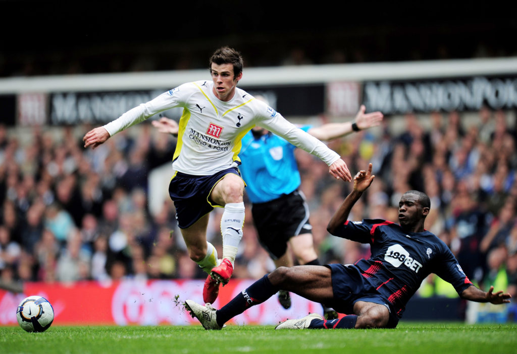 Gareth Bale of Tottenham Hotspur avoids a challenge from Fabrice Muamba of Bolton Wanderers during the Barclays Premier League match between Totten...