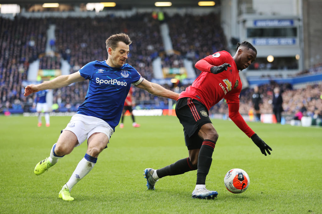 Aaron Wan-Bissaka of Manchester United is challenged by Leighton Baines of Everton during the Premier League match between Everton FC and Mancheste...