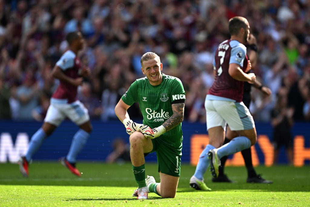 Jordan Pickford of Everton looks dejected after Jhon Duran of Aston Villa scores their team's fourth goal during the Premier League match between A...