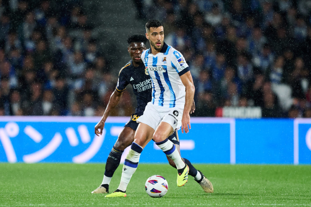 Aurelien Tchouameni of Real Madrid duels for the ball with Mikel Merino of Real Sociedad during the LaLiga EA Sports match between Real Sociedad an...