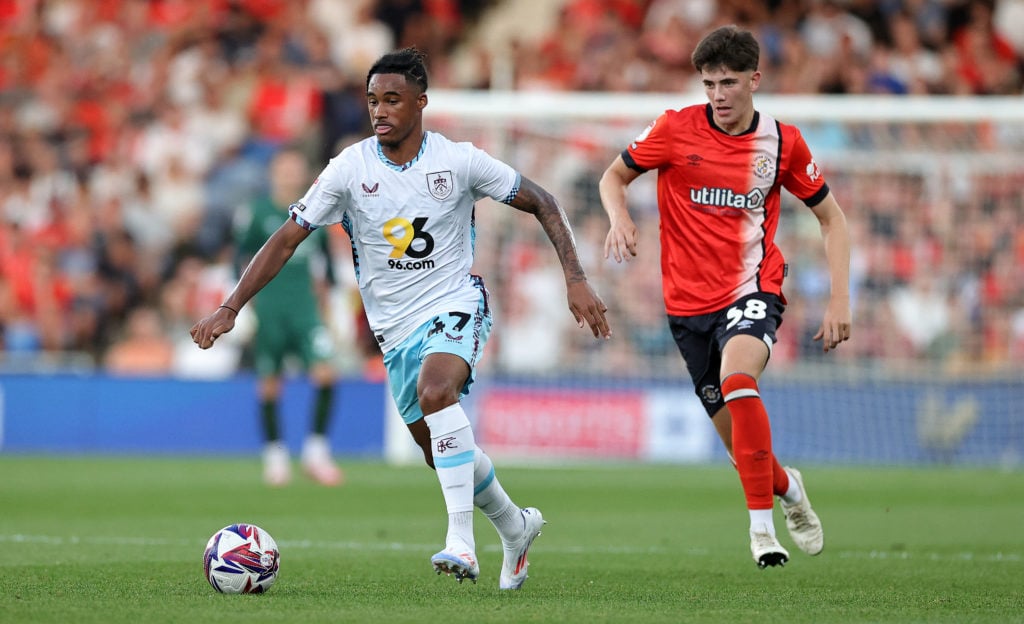 Wilson Odobert of Burnley moves away from Joe Johnson during the Sky Bet Championship match between Luton Town FC and Burnley FC at Kenilworth Road...