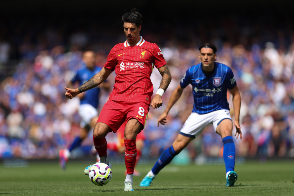 Dominik Szoboszlai of Liverpool runs with the ball under pressure from Jacob Greaves of Ipswich Town during the Premier League match between Ipswic...