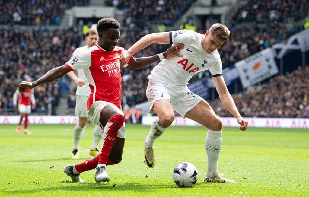 Bukayo Saka of Arsenal (left) battles with Mickey van de Ven of Tottenham Hotspur during the Premier League match between Tottenham Hotspur and Ars...