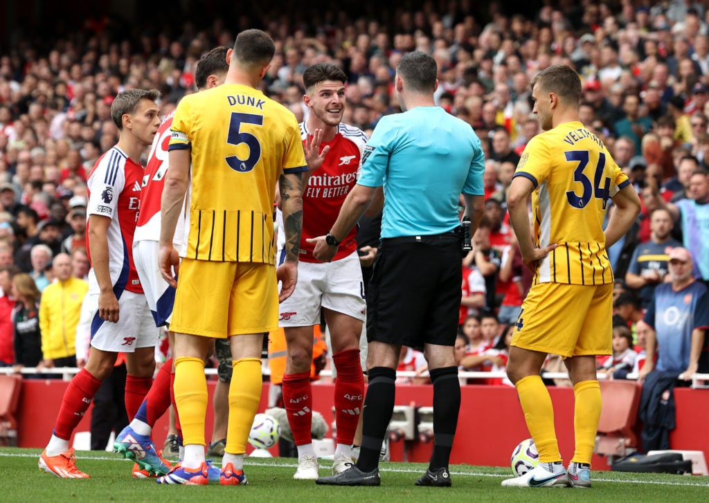 Declan Rice of Arsenal interacts with match referee Chris Kavanagh after being shown a second yellow card during the Premier League match between A...