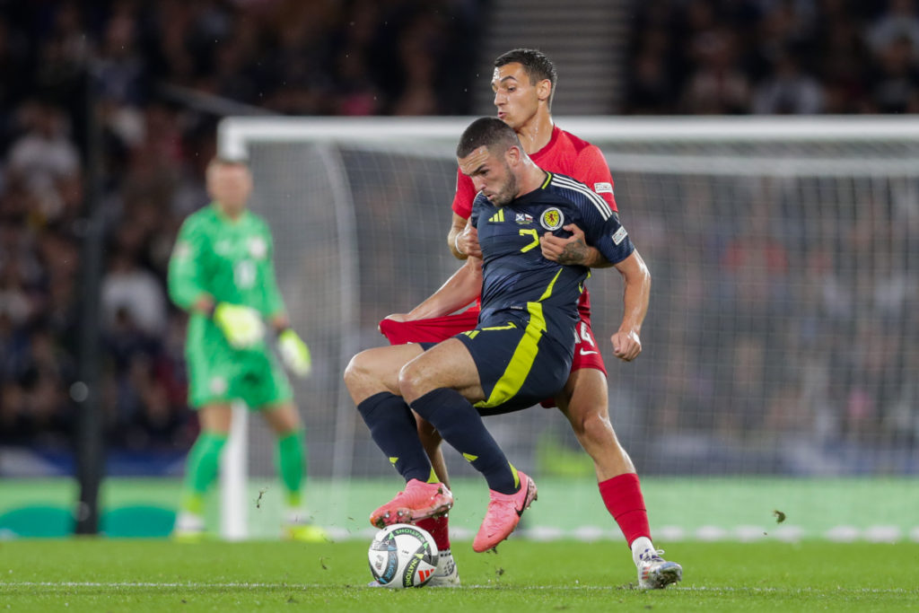 John McGinn of Scotland (L) and Jakub Kiwior of Poland (R)