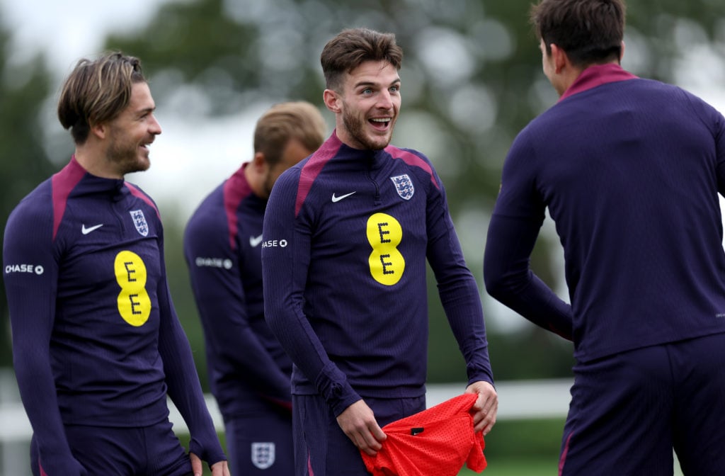 Jack Grealish and Declan Rice of England react during a training session at Tottenham Hotspur Training Centre on September 09, 2024 in Enfield, Eng...