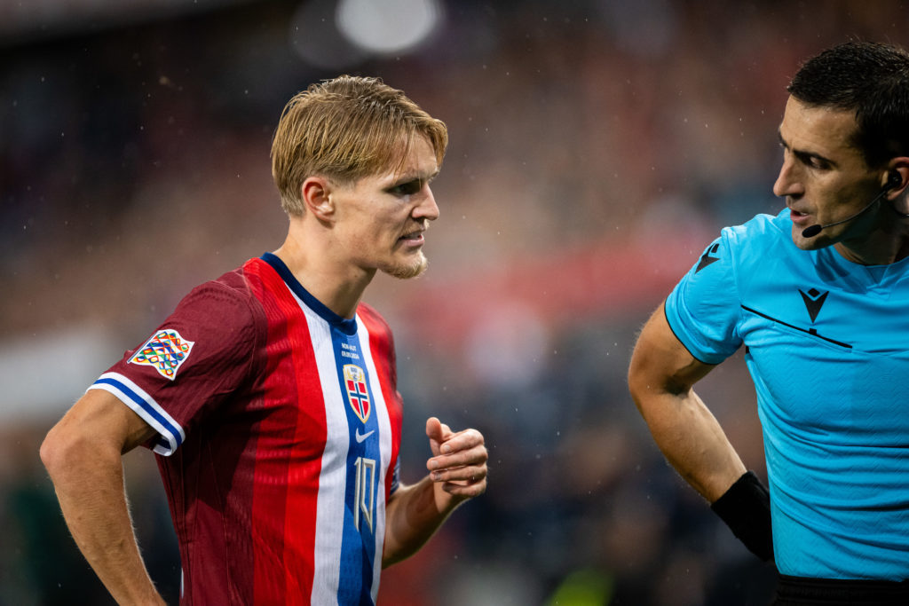 Martin Odegaard of Norway and Referee Nikola Dabanovic discuss during the UEFA Nations League 2024/25 League B Group B3 match between Norway and Au...