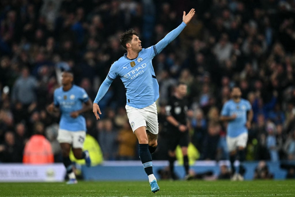 TOPSHOT - Manchester City's English defender #05 John Stones scores the equalising goal during the English Premier League football match between Ma...