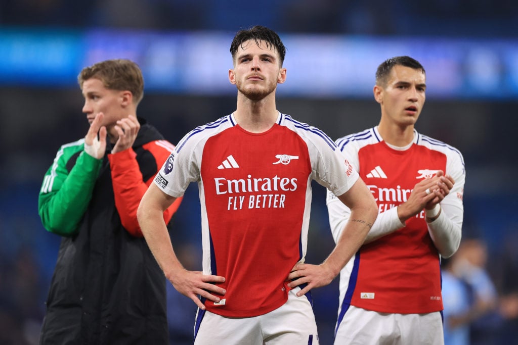 Declan Rice of Arsenal (C) and Jakub Kiwior of Arsenal (R) look dejected after the Premier League match between Manchester City FC and Arsenal FC a...