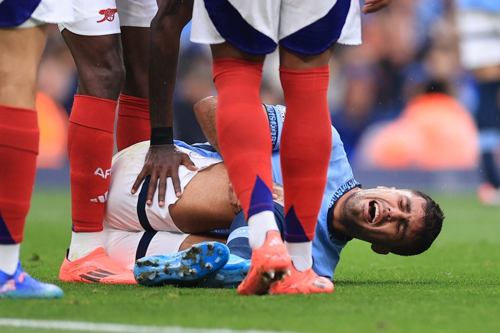 Rodri of Manchester City lies injured during the Premier League match between Manchester City FC and Arsenal FC at Etihad Stadium on September 22, ...