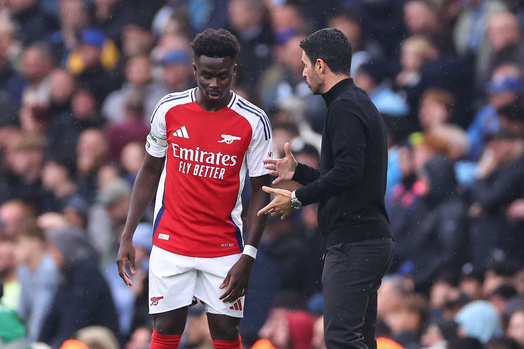 Bukayo Saka of Arsenal is instructed by Mikel Arteta manager / head coach  of Arsenal during the Premier League match between Manchester City FC an...