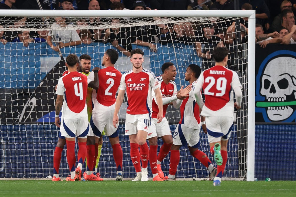 Teammates celebrate with David Raya of Arsenal FC after the goalkeeper saved a penalty from Matteo Retegui of Atalanta and a further header from th...