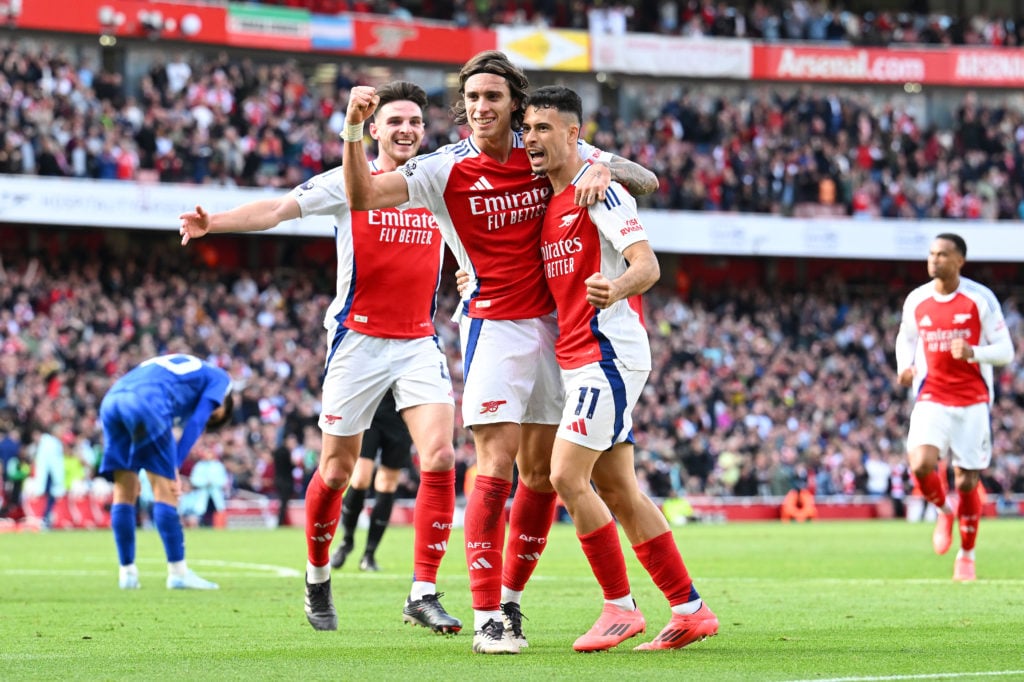 Declan Rice, Riccardo Calafiori and Gabriel Martinelli of Arsenal celebrate after teammate Leandro Trossard (not pictured) scores his team's second...