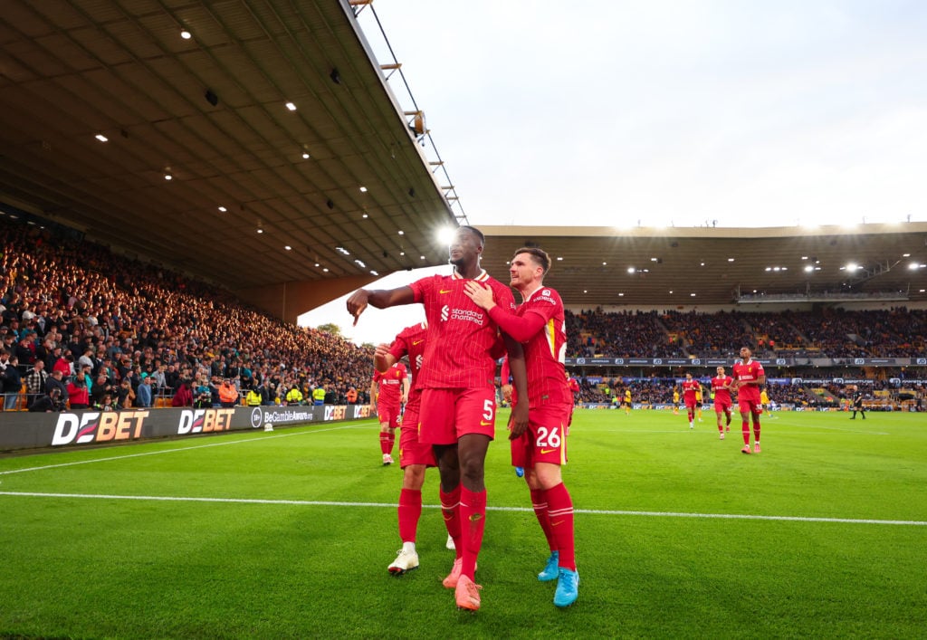 Ibrahima Konate of Liverpool celebrates scoring the first goal with Andrew Robertson of Liverpool during the Premier League match between Wolverham...