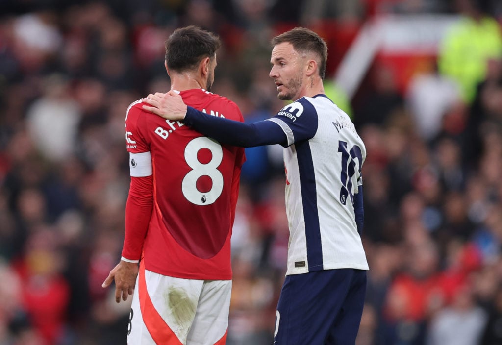 James Maddison of Tottenham Hotspur speaks with Bruno Fernandes of Manchester United. as he leaves the pitch having been shown a red card during th...