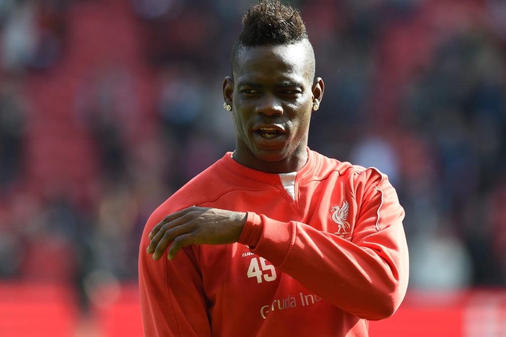 Liverpool's Italian striker Mario Balotelli warms up ahead of the English Premier League football match between Liverpool and Manchester United at ...