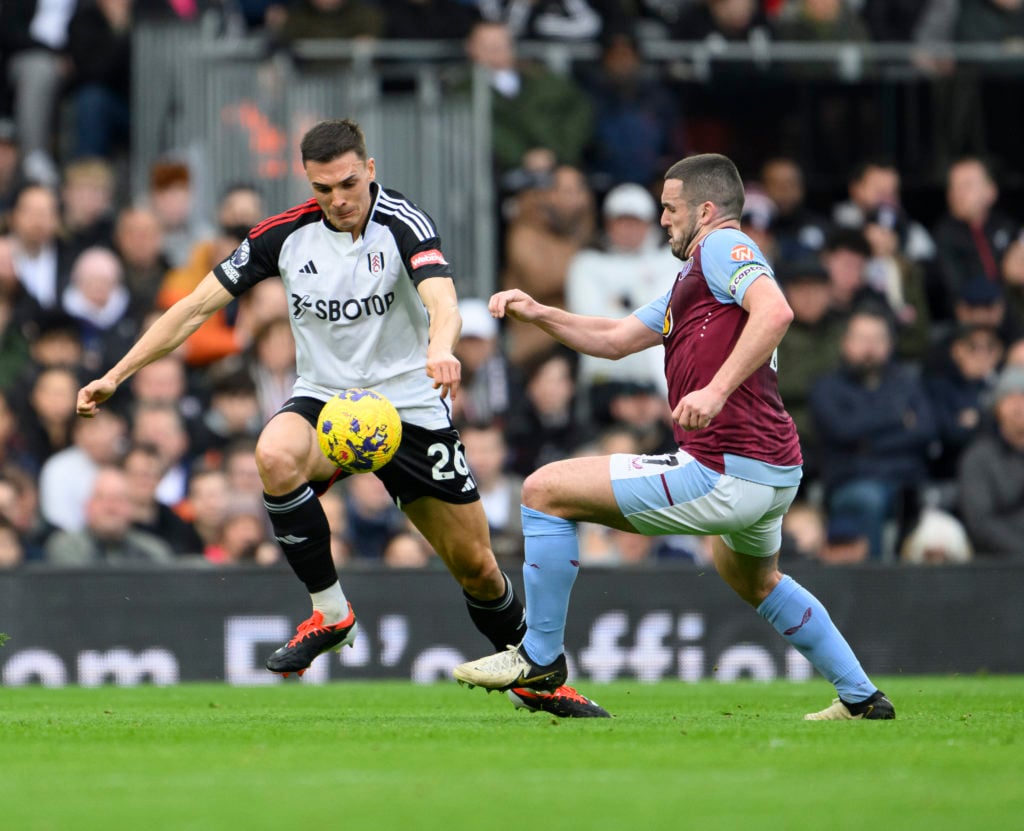 Aston Villa's John McGinn (right) battles with Fulham's Joao Palhinha (left) during the Premier League match between Fulham FC and Aston Villa at C...