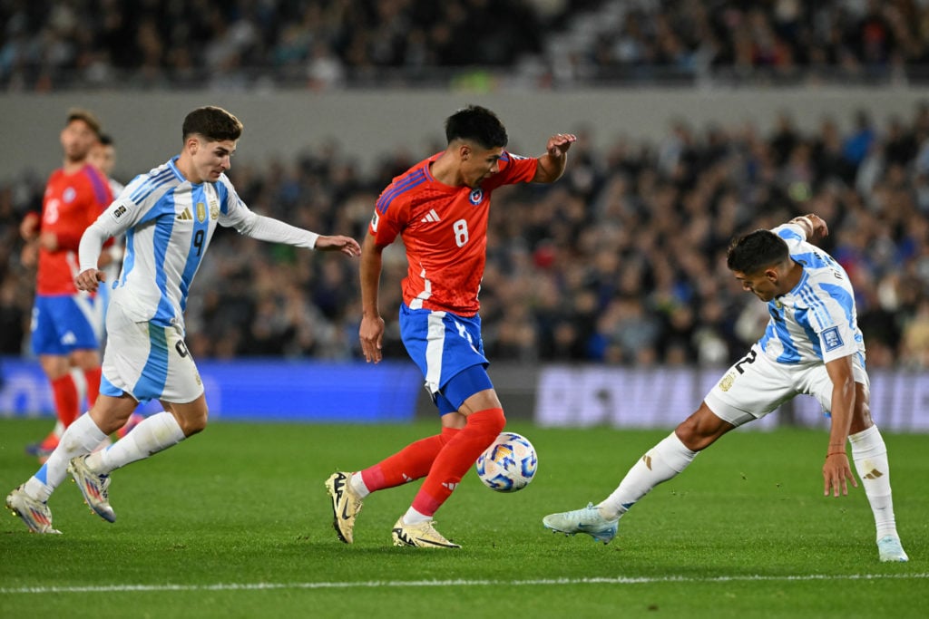 Chile's forward Dario Osorio (C) fights for the ball with Argentina's forward Julian Alvarez (L) and defender Nahuel Molina during the 2026 FIFA Wo...