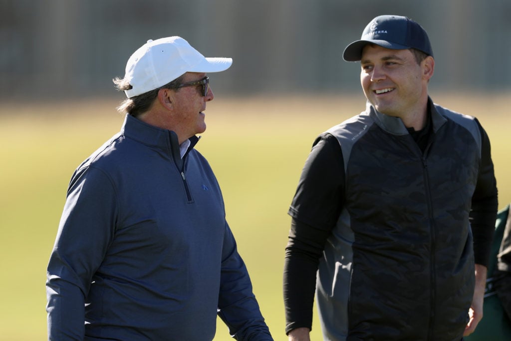 CEO of The Friedkin Group, Dan Freidkin interacts with his son, Ryan Freidkin, Co-Founder of Imperative Entertainment during a practice round prior...