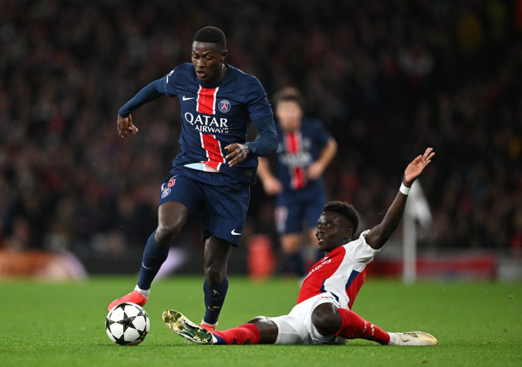 Nuno Mendes of Paris Saint-Germain is challenged by Bukayo Saka of Arsenal during the UEFA Champions League 2024/25 League Phase MD2 match between ...