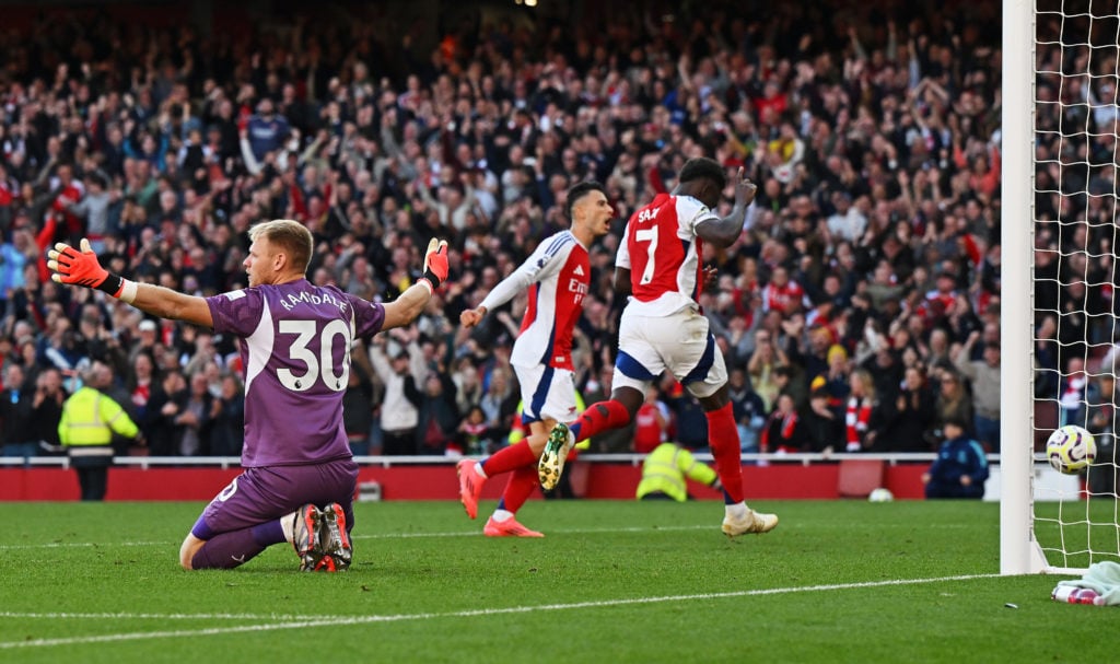 Bukayo Saka of Arsenal scores his team's third goal past Aaron Ramsdale of Southampton during the Premier League match between Arsenal FC and South...