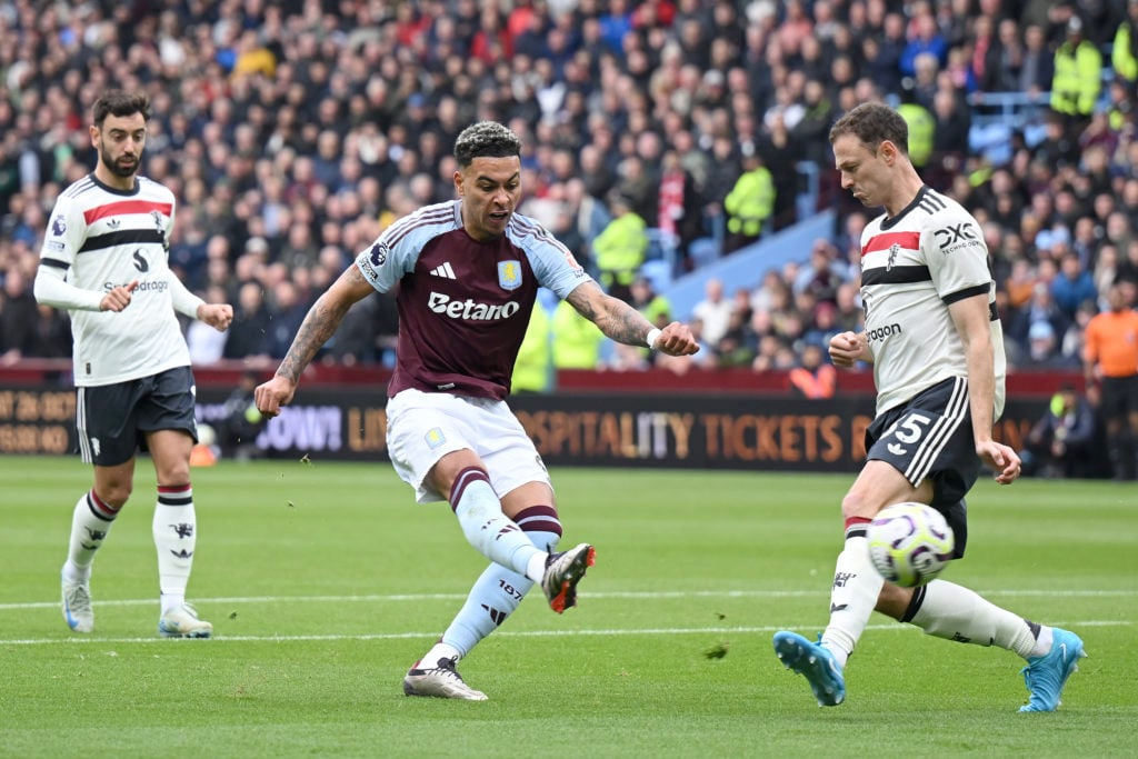 Morgan Rogers of Aston Villa is challenged by Jonny Evans of Manchester United during the Premier League match between Aston Villa FC and Mancheste...