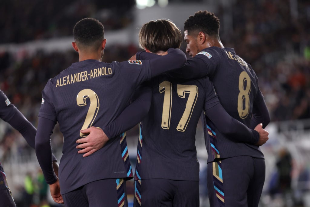 Jack Grealish of England celebrates scoring his team's first goal with teammates Trent Alexander-Arnold and Jude Bellingham during the UEFA Nations...