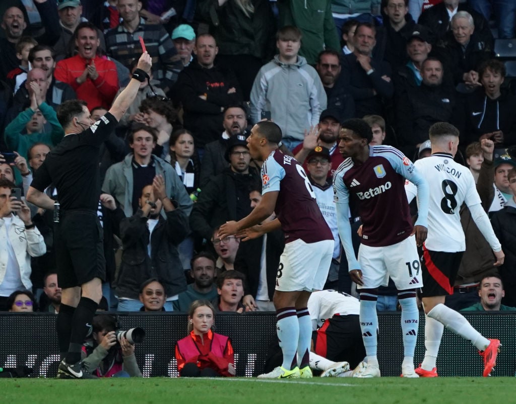 Aston Villa's Jaden Philogene-Bidace is shown a red card by Referee Darren England during the Premier League match between Fulham FC and Aston Vill...