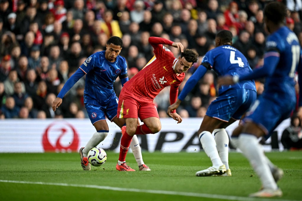 Chelsea's English defender #06 Levi Colwill fouls Liverpool's English midfielder #17 Curtis Jones leading to a penalty during the English Premier L...