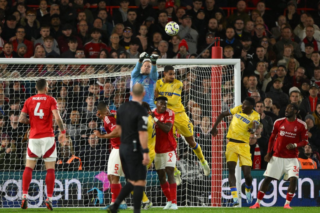 Matz Sels, Nottingham Forest goalkeeper, punches the ball under pressure from Maxence Lacroix of Crystal Palace during the Premier League match bet...