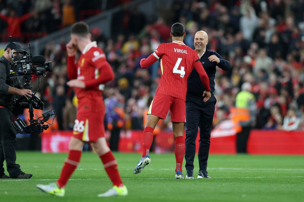 Arne Slot, Manager of Liverpool, embraces Virgil van Dijk of Liverpool after the team's victory during the Premier League match between Liverpool F...