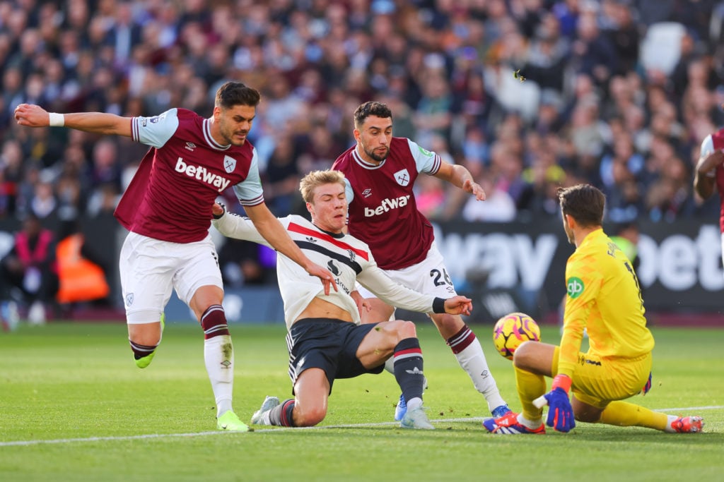 Rasmus Hojlund of Manchester United has a shot saved by Lukasz Fabianskiof West Ham United as he battles for possession with Konstantinos Mavropano...