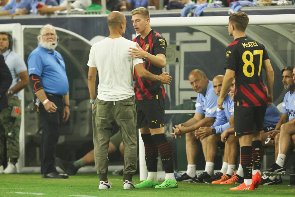 Pep Guardiola the manager / head coach of Manchester City in discussion with Liam Delap of Manchester City during the pre season friendly between M...