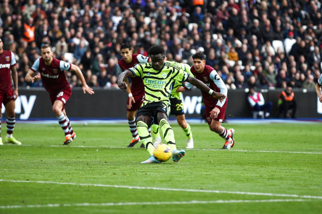 Bukayo Saka is scoring from the penalty spot during the Premier League match between West Ham United and Arsenal at the London Stadium in Stratford...