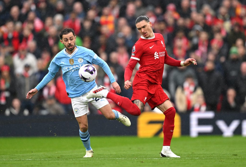 Darwin Nunez of Liverpool controls the ball whilst under pressure from Bernardo Silva of Manchester City during the Premier League match between Li...