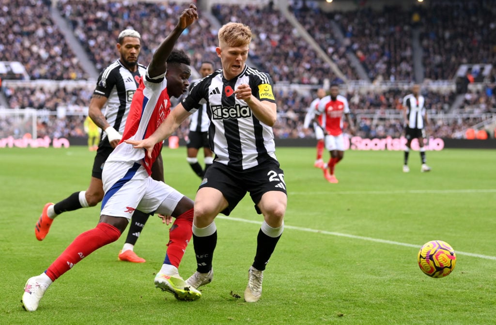 Bukayo Saka of Arsenal battle for possession Lewis Hall of Newcastle United during the Premier League match between Newcastle United FC and Arsenal...