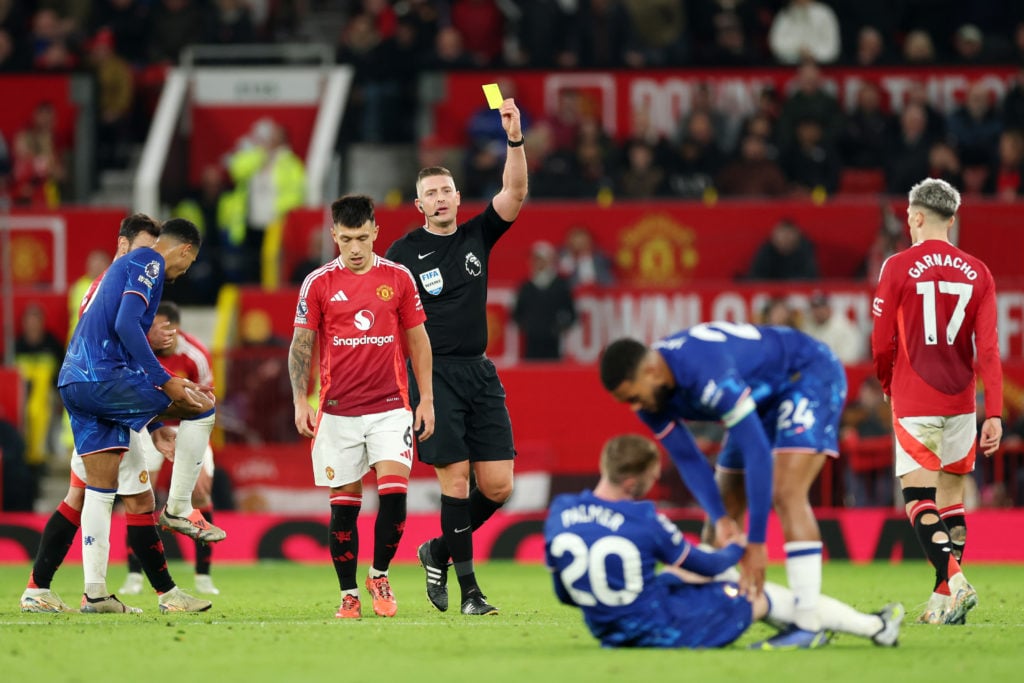 Lisandro Martinez of Manchester United is shown a yellow card from referee Robert Jones after a foul on Cole Palmer of Chelsea during the Premier L...