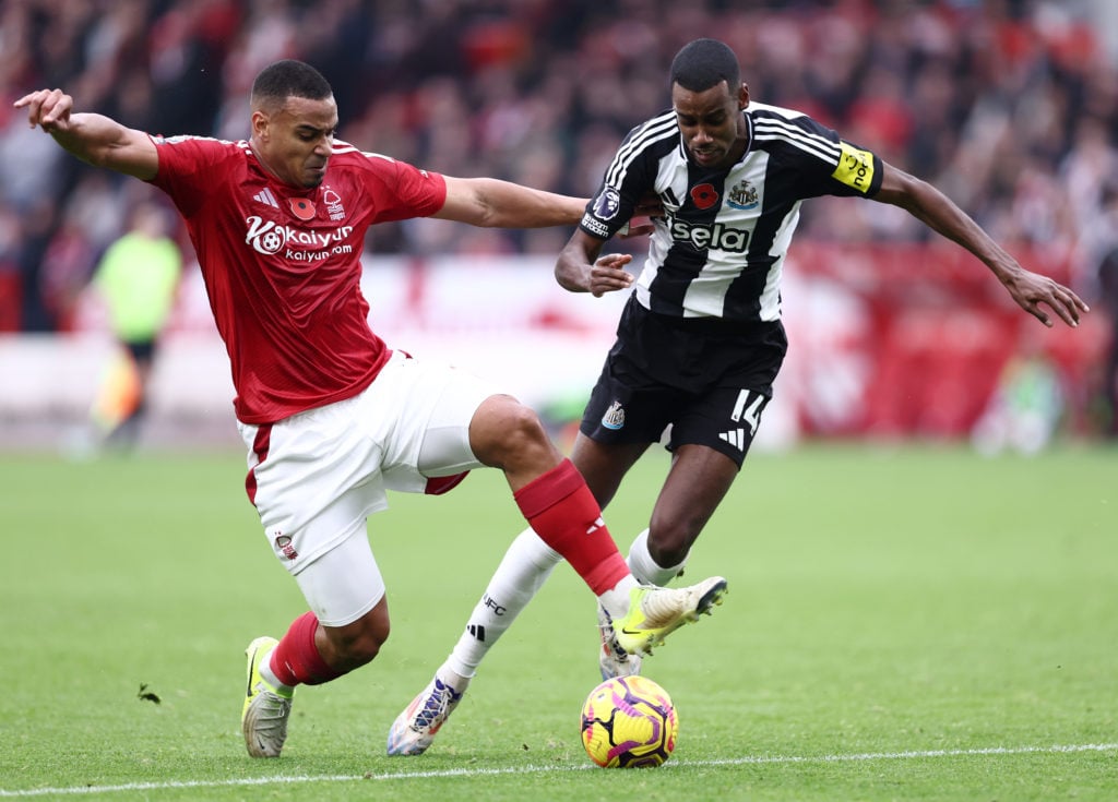 Alexander Isak of Newcastle United is challenged by Murillo of Nottingham Forest during the Premier League match between Nottingham Forest FC and N...