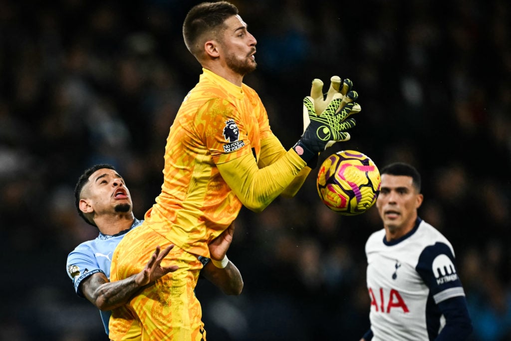 Manchester City's Brazilian midfielder #26 Savinho (L) collides with Tottenham Hotspur's Italian goalkeeper #01 Guglielmo Vicario (C) as they fight...